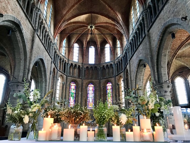 altar decoration with candles and greens