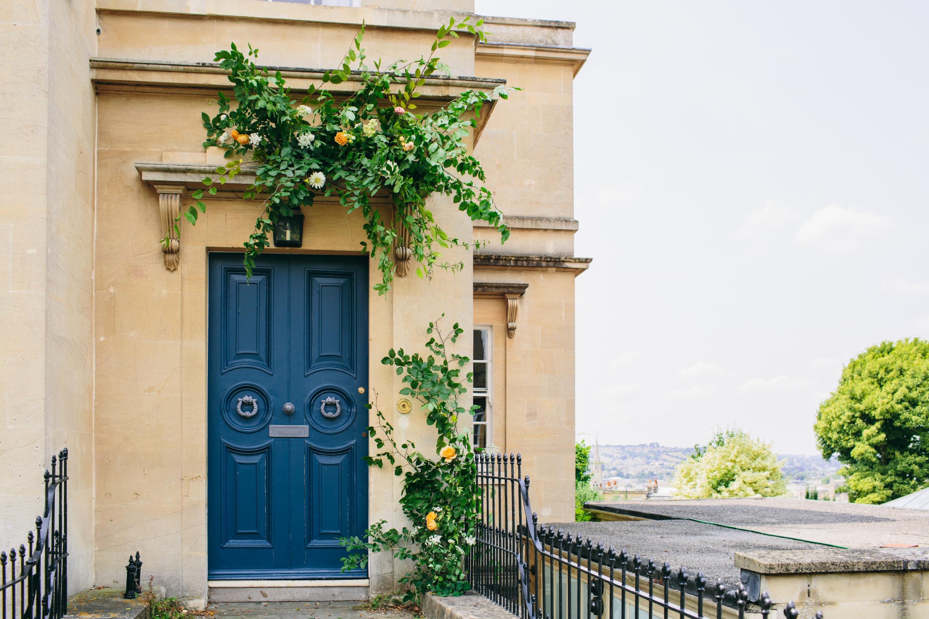 blue front door with flower decoration