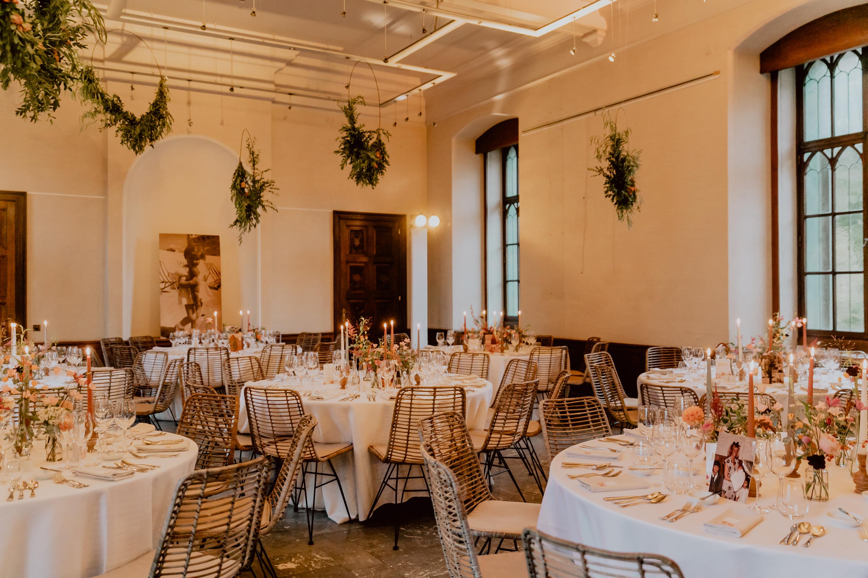 table setting with flower sand candles, and hanging hoolahoops with greens