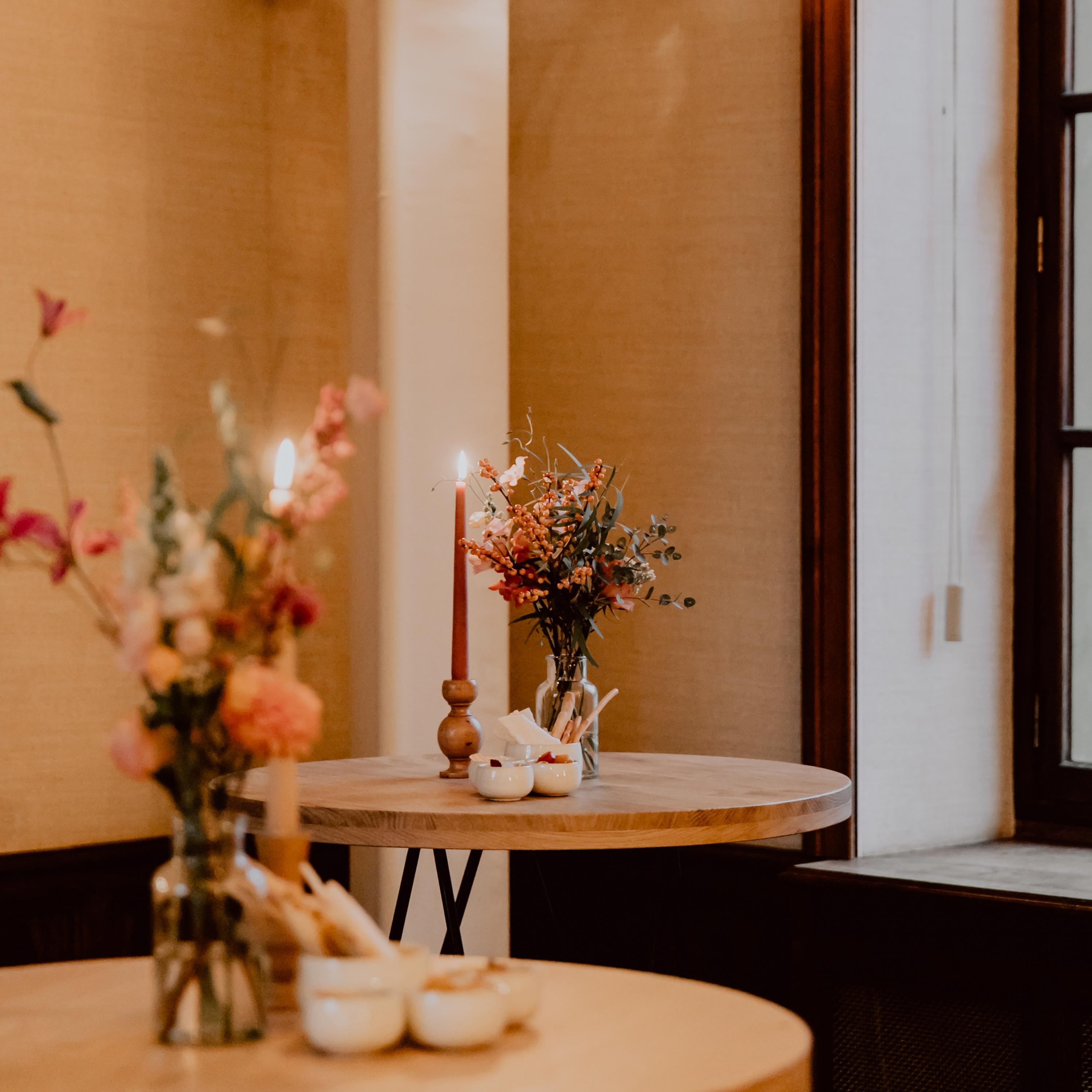 vases with flowers on a reception table